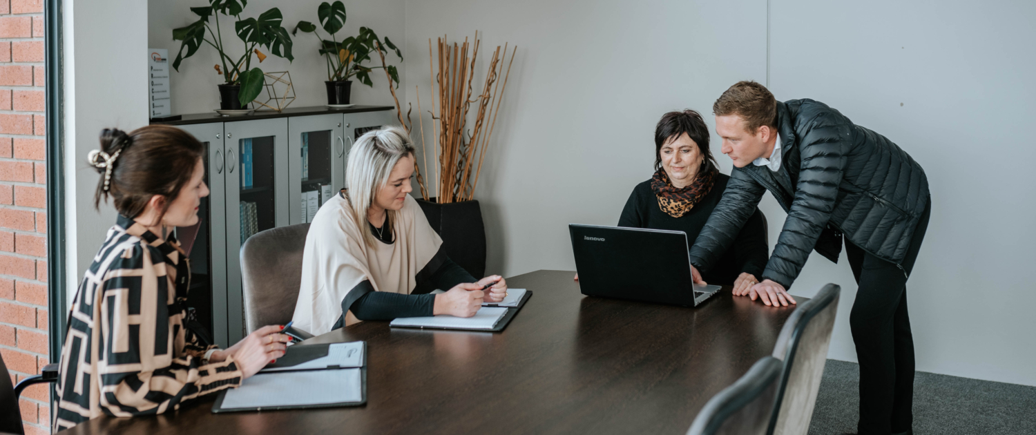 Team collaborating around a board table in a meeting